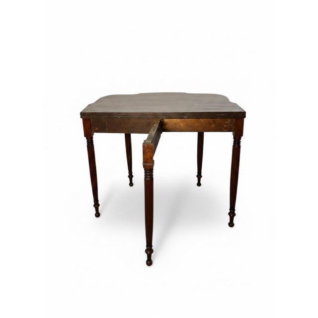 Elegant early 19th-century American mahogany flip-top card or game table in the Sheraton tradition, featuring a...