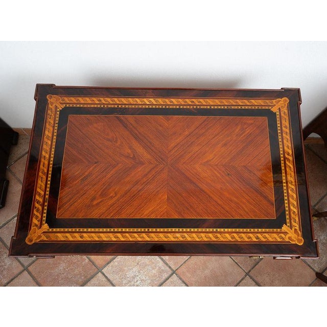 An antique Lombard center desk made of fine woods, dating from the second half of the 18th century. The top features a...