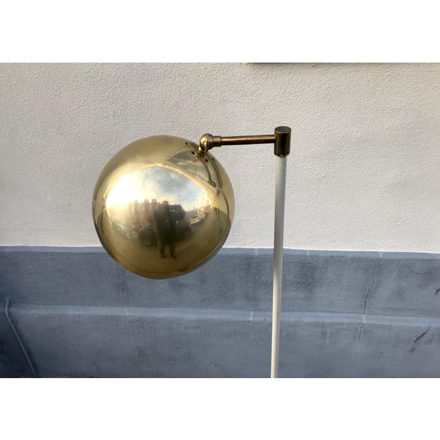 Unusual Scandinavian floor lamp with an adjustable spherical shade in brass. Anonymous maker/design in the style of Verner...
