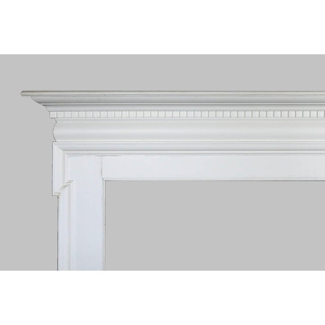 Antique English painted fireplace mantel with moulding and dentil trim across the top. Opening dimensions:W:50" x H:36.25".
