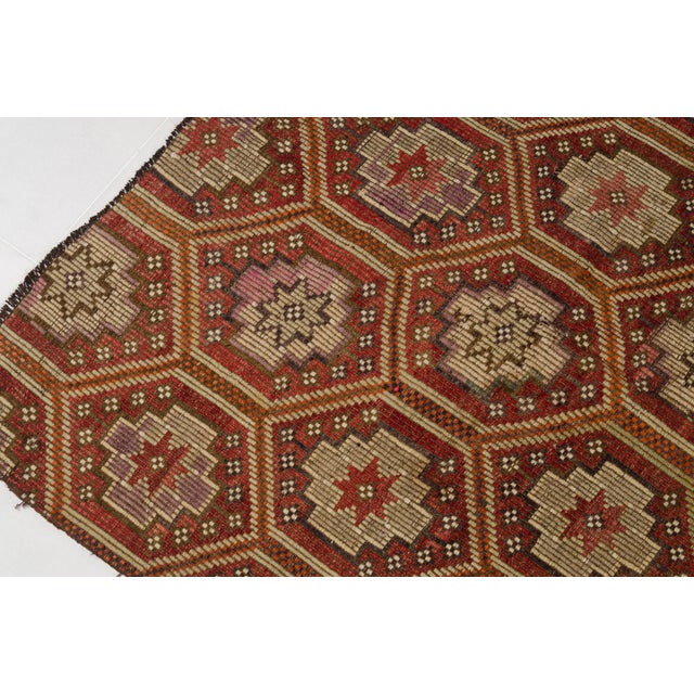This is a vintage Turkish Oushak rug from the Mid 20th Century. The piece was hand-knotted.