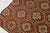 This is a vintage Turkish Oushak rug from the Mid 20th Century. The piece was hand-knotted.