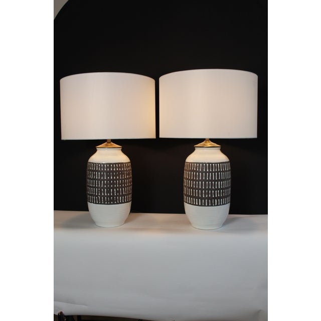 A substantial pair of Martz influence table lamps. Cream ceramic with embossed chestnut brown overlay. Giving lamps...