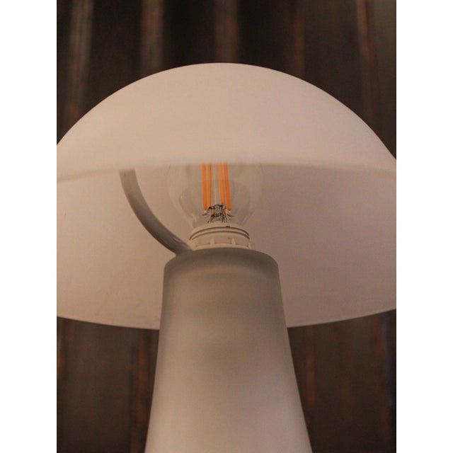 Elegant vintage Italian lamp from the 1970s, crafted from white Murano-style glass. Its organic and minimalist design adds...