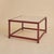 A 1970s Italian coffee table featuring a travertine top set within a lacquered red wood frame. The rectangular stone...