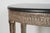 A Neoclassical-Style Silvered Wood Demilune Console Table with faux stone top Dimensions: 33 1/4 x 47 3/4 x 23 1/4 in....