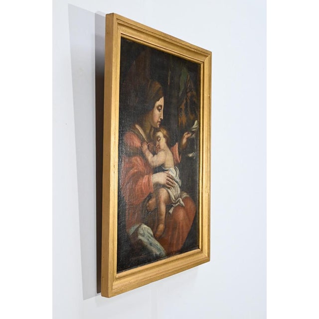 Oil painting on canvas depicting, in a large pastille, the Virgin Mary seated on a rock in a wood and her child Jesus. The...