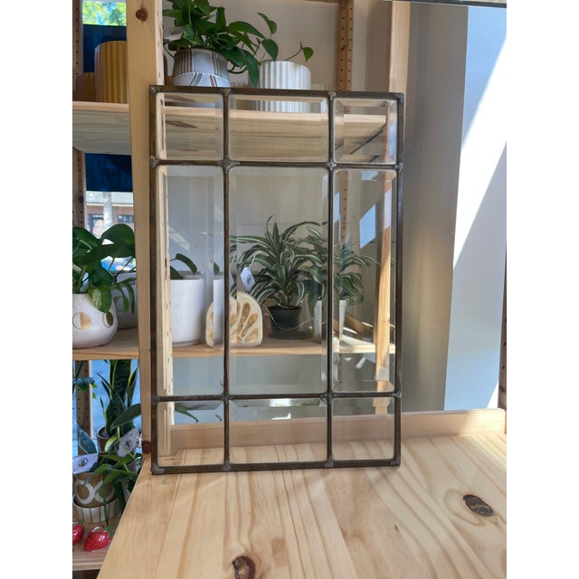 Offered is a vintage leaded glass window panel featuring clear beveled glass set within metal caming. Each panel is...