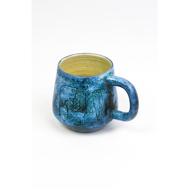 Glazed earthenware; sgraffito decoration hand-engraved on slip before firing, a cloud-effect metallic oxide glaze applied...