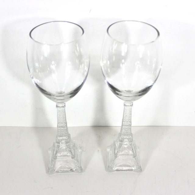Pair of vintage Eiffel Tower wine glasses. Clear pressed glass bases in the shape of the Eiffel Tower and clear blown...