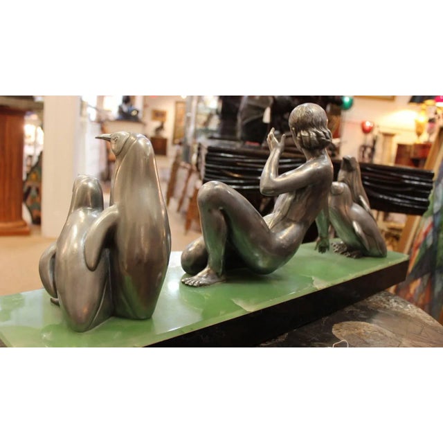 Classic Art Deco silvered bronze of female dancer with penguins. The center figure is a semi nude athletic female flaked...