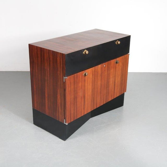 A rare sideboard designed and manufactured by De Coene in Belgium, circa 1960. This beautiful piece has a wonderful,...