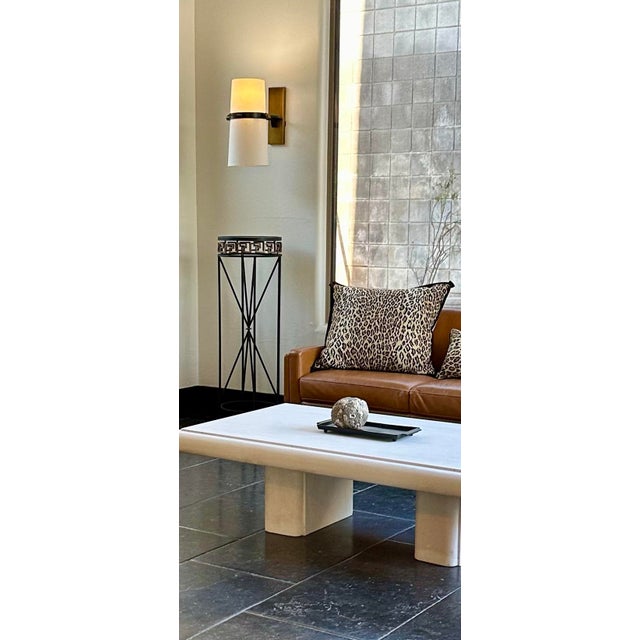 A chic pair of Regency-style Art Deco pedestals stands. The hand-forged cylindrical iron silhouettes and Greek keys have...