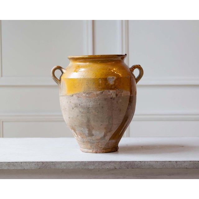 This striking 19th-century French terracotta jug is a beautiful example of utilitarian pottery turned timeless décor....