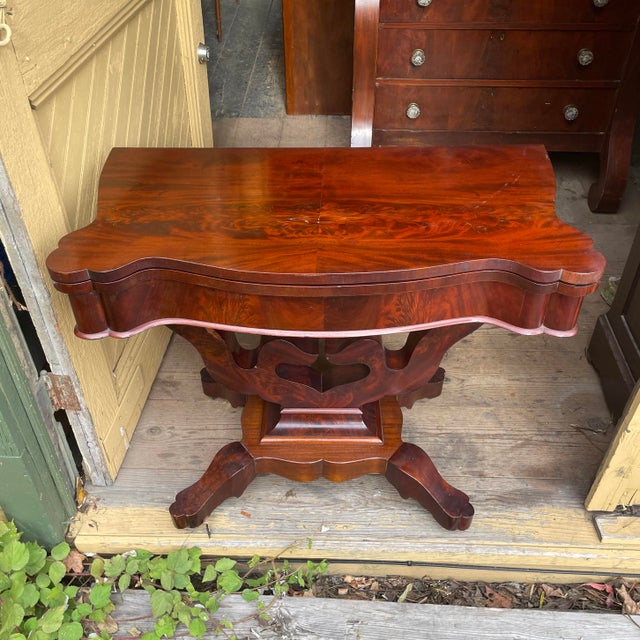 Large crotch mahogany Empire style(1800s) flip-top game table—top swivels to reveal a space for your favorite board or...