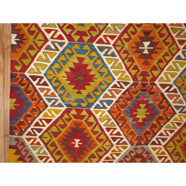 Colorful vintage Turkish Kilim flat-weave from the mid-20th century. Cherry red, chartreuse, and orange dominant accents...