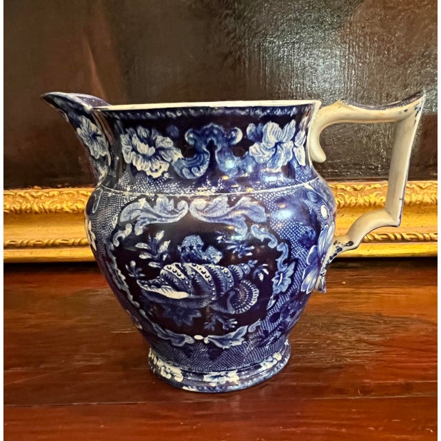 This outstanding circa 1830 dark blue transfer-decorated Staffordshire pitcher was made by Joseph Stubbs of Longport,...