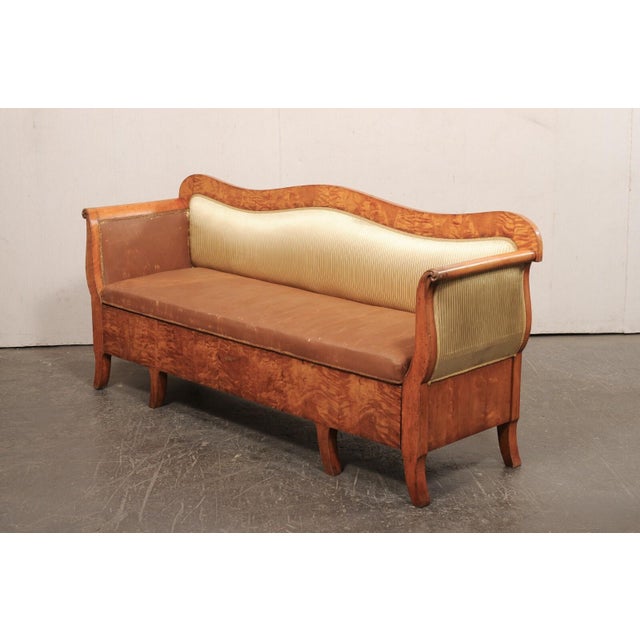 A Swedish Biedermeier upholstered sofa, with quilted curly birch veneers, from the mid 19th century. This antique sofa...