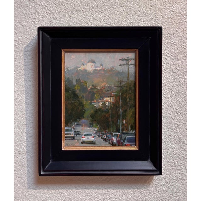 This oil painting captures a bustling street scene, leading the viewer's eye toward an observatory perched on a distant...