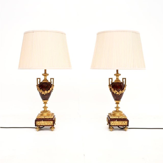 An absolutely stunning pair of antique French marble and gilt bronze lamps. They were made in France, they date from...