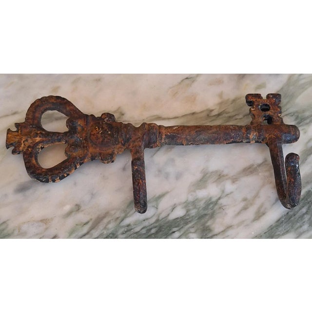 A fancy European style key with intentional aged, corroded patina creates a fashionable place to hold one's keys, hat or...