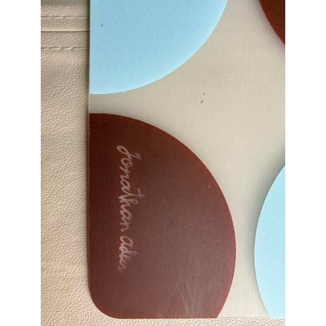 a set of 8 Jonathan Adler designed reversible vinyl placemats. Printed with circles in robins egg blue and brown on a...