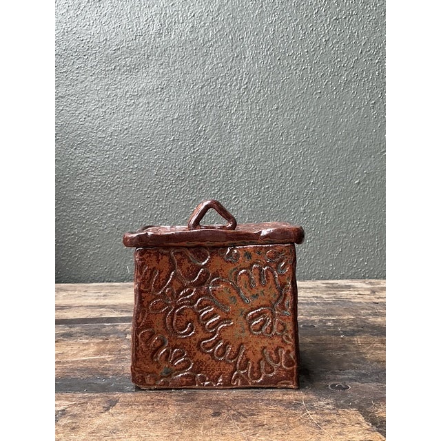This charming studio pottery box is a masterclass in the organic warmth and tactile expression of the late 20th-century...