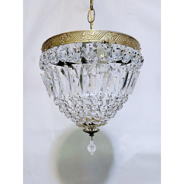 Add a touch of timeless, romantic glamour to your space with this exquisite vintage mid-century tiered brass crystal...