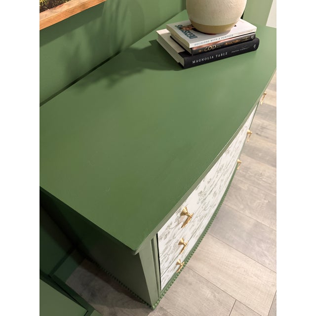 Beautiful dresser/accent table with a rich green finish and stunning floral drawer fronts. This piece has been...