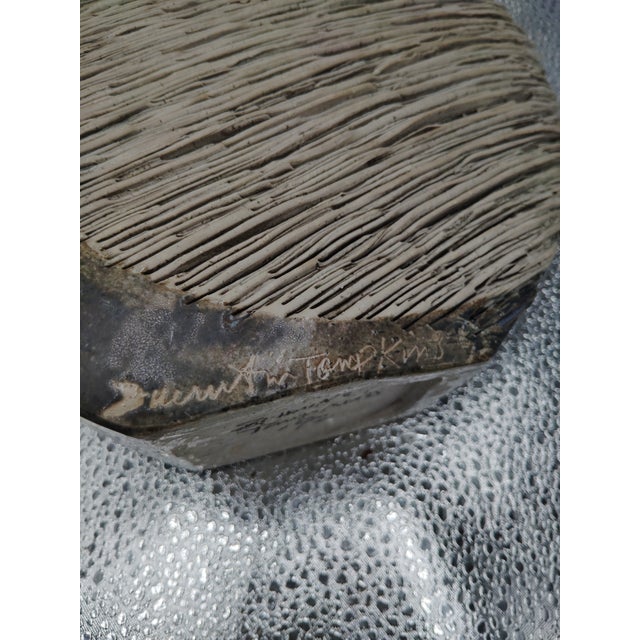 This vase is a quarter moon shape; the texture is sculptured at 9 1/2" x 9 1/2" x 2 7/8" with 3 1/2" slit at the top. The...