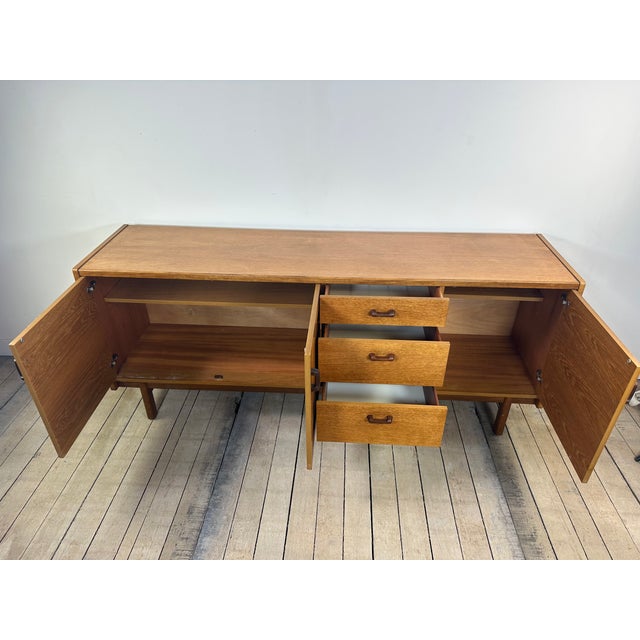 Authentic Scandinavian sideboard from the 1970s, crafted from teak with a beautiful warm patina and particularly elegant...