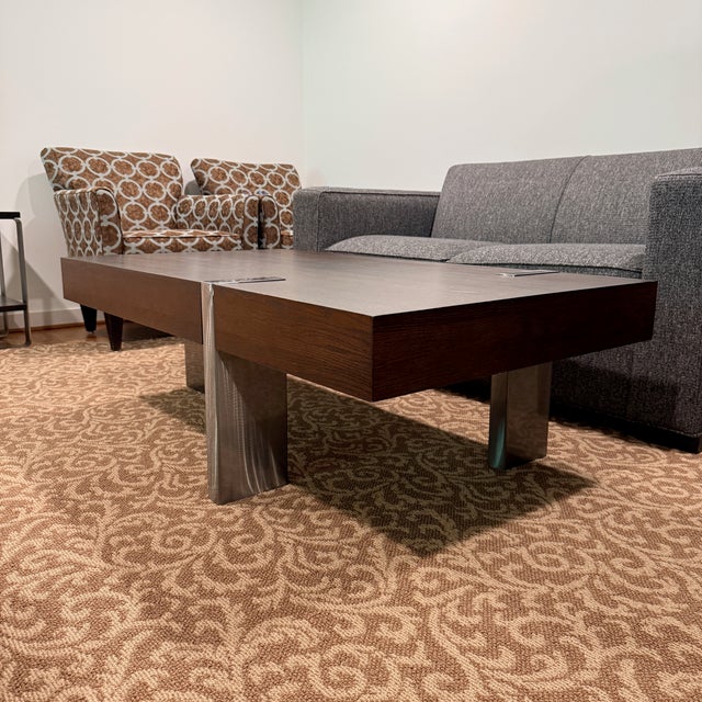 Arcadia Rectangle Cocktail Table This modern wooden cocktail table features striking metallic leg accents that wrap neatly...