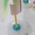 Set of three Italian Modernist Table lamps. Painted metal with glass bases and each with a round hanging glass plate in...