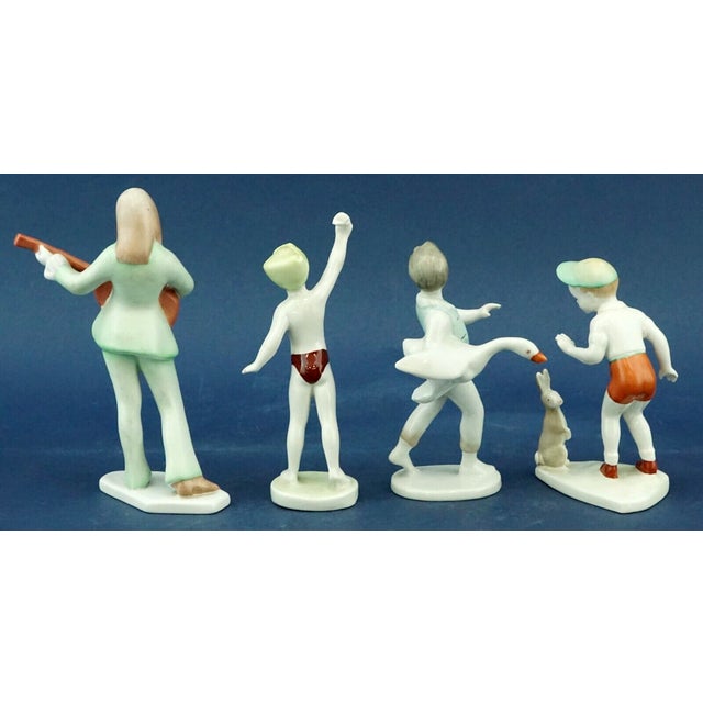 Measurements: boy with goose: height: 13.5 cm; width: 8 cm; depth: 6 cm boy with rabbit: height: 12 cm; width: 7 cm;...