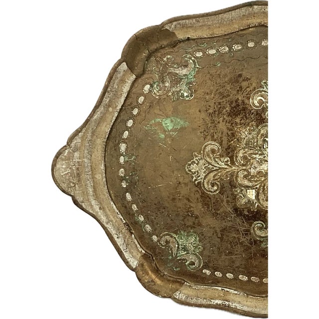20th century large Florentine giltwood serving tray with handles. Has green floral accents among the gold, back of tray is...