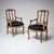 Set of six carved solid oak side chairs and two armchairs, newly upholstered in a black striped fabric. The openwork backs...