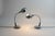 A pair of chrome-plated desk lamps with stainless steel bases from the 1970's made in Italy, these goose neck style lamps...