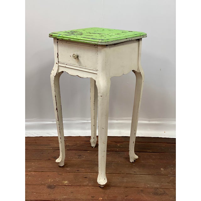 Sweet American Queen Anne style end table. Old distressed green painted top with a white base. The piece is constructed...