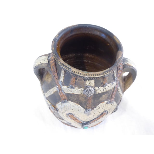 This Antique Moroccan ceramic vase has metal work in silver and copper and semi-precious stones..