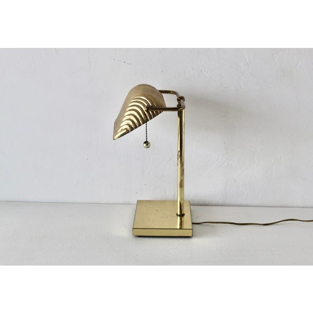 Vintage sleek George Kovacs 1980s brass banker's or piano desk lamp with a ribbed, adjustable metal shade and a...