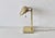 Vintage sleek George Kovacs 1980s brass banker's or piano desk lamp with a ribbed, adjustable metal shade and a...