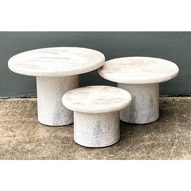 This vintage set of three side tables is crafted from textured resin to mimic the appearance of stone, bringing a...