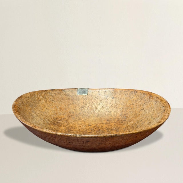 Carved from a single burl of ash, this 18th-century Native American bowl—likely from the Northeastern United...