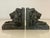 Distinguished pair of lion bookends made of resin and richly finished with the look of aged bronze with verdigris. From a...