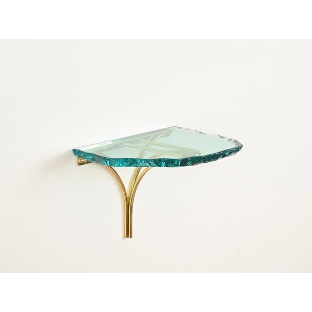 Magnificent and extremely rare pair of mid-century wall-mounted nightstands or shelves in solid gilt brass and thick...