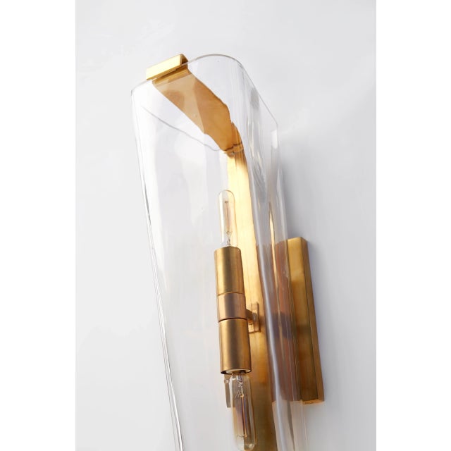 Alpine Single Sconce in Hand-Rubbed Antique Brass with Clear Glass Designer: AERIN Height: 16.25" Extension: 7.75"...