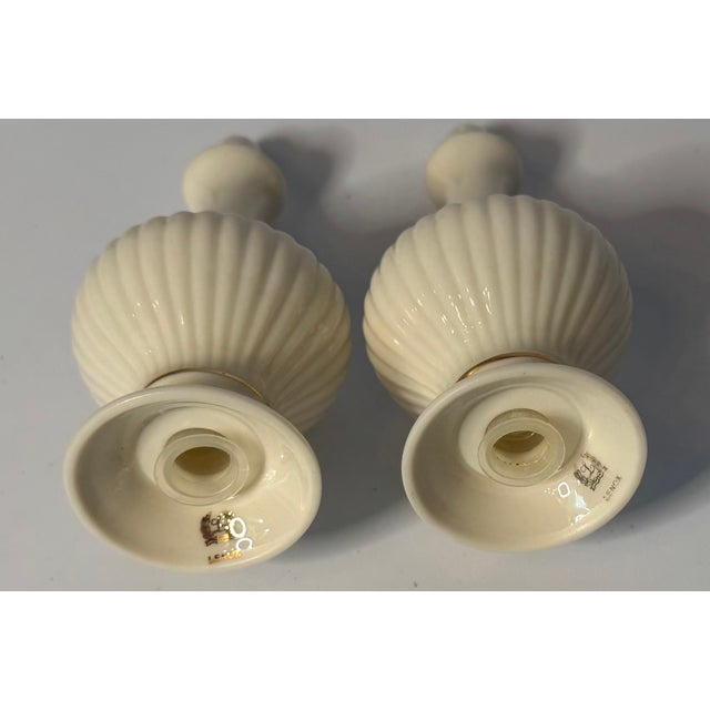 Classic Lenox ivory salt & pepper shakers with gold trim—timeless American elegance. A refined pair of vintage Lenox...