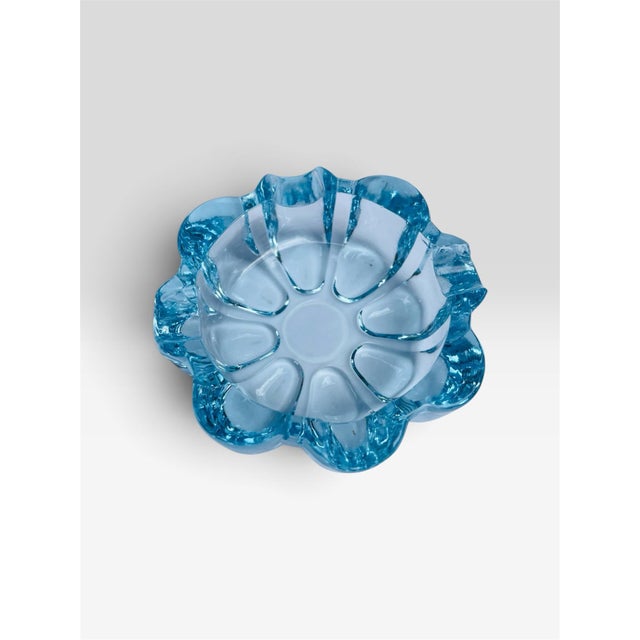 A blue Fosteria Company glass ashtray. Perfect holder of collectible items.