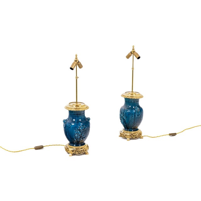Pair of ceramic lamps in blue and gilded and chiseled bronze. French work realized circa 1880. Openwork bronze base. This...
