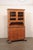 A tall French two-piece wooden cabinet from the 19th-century. This antique cabinet from France, often referred to as...